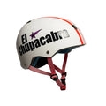 Child wearing a white helmet with 'El Chupacabra' text and star logo in a room.